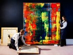 Gallery technicians hanging Abstraktes Bild (809-4) by Gerhard Richter at Sotheby's Photograph: Linda Nylind for the Guardian